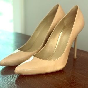 Stuart Weitzman nude patent leather pump.